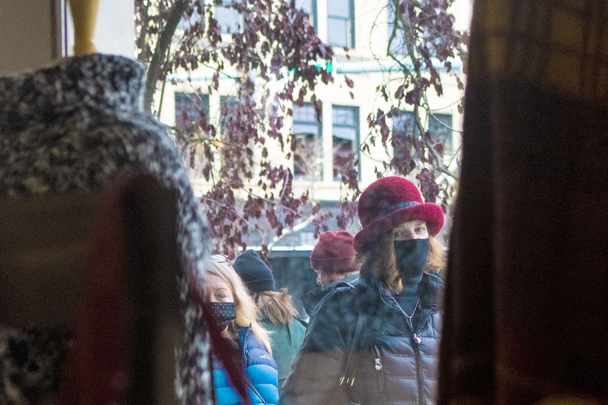 Masked shoppers walk along Sherman Avenue in Coeur d’Alene last month as Idaho moves back to Stage 3 due to increasing COVID-19 spread. (Kathy Plonka/The Spokesman-Review)