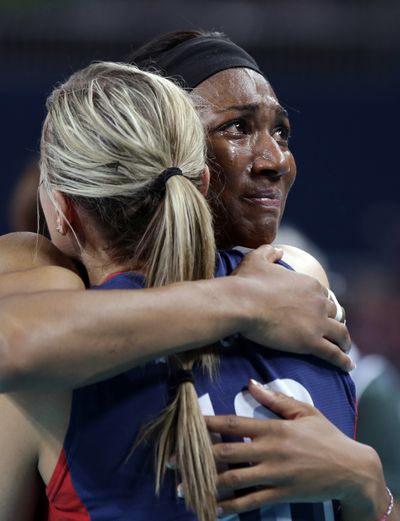 USA’s Foluke Akinradewo, right, cries as she hugs teammate Jordan Larson. (Associated Press)
