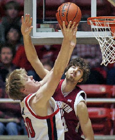 
Utah's Luke Nevill goes to the rim, while WSU's Robbie Cowgill defends. 
 (Associated Press / The Spokesman-Review)
