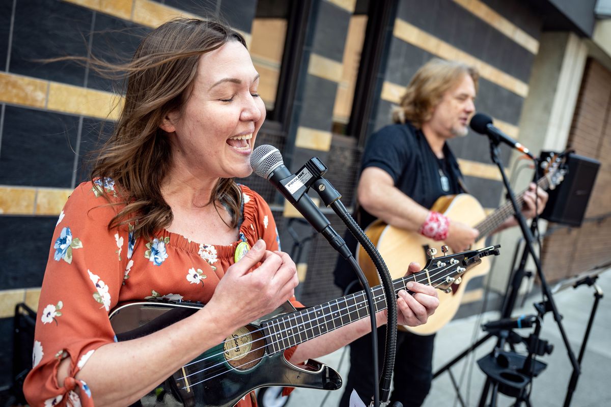 Dalyn Harper and Max Malone of the band “Diary” perform on Main Street during the last day Street Music Week, The 21st annual event raised money for Second Harvest Inland Northwest food bank. For the noon hour, Harper and Malone performed an eclectic mix of country rock, top 10 with some Bee Gees and Tina Turner added to the mix.  (COLIN MULVANY/THE SPOKESMAN-REVI)