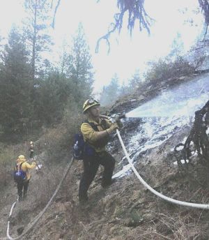 Coeur d'Alene firefighters battle a small blaze on Tubbs Hill Tuesday afternoon. The Coeur d'Alene Fire Department is back on the scene this morning to check out smoke coming from the burn site. (Coeur d'Alene Fire Department / Courtesy Photo)
