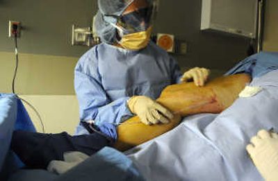 
Dr. Renu Sinha of the Rockwood Clinic Vein Institute performs endovenous laser ablation on Mary Damascus at Spokane Valley Hospital. The laser treatment is becoming widely used as an alternative to more invasive varicose vein stripping procedures. 
 (Photos by Dan Pelle / The Spokesman-Review)