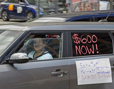 Motorists take part in a caravan protest in front of Sen. John Kennedy's office at the Hale Boggs Federal Building asking for the extension of the $600 in unemployment benefits to people out of work because of the coronavirus in New Orleans on Wednesday, July 22, 2020.  (Associated Press)