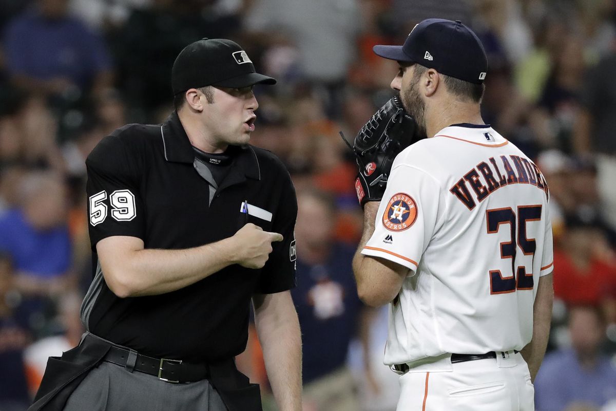 Houston Astros starting pitcher Justin Verlander (35) talks with home plate umpire Nic Lentz (59) after being called for a balk during the second inning of the team's baseball game against the Seattle Mariners on Thursday, Aug. 9, 2018, in Houston. (David J. Phillip / AP)