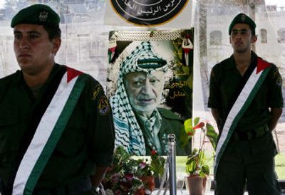 
Palestinian honor guards stand at the late Palestinian leader Yasser Arafat's grave in the West Bank city of Ramallah Thursday. A 