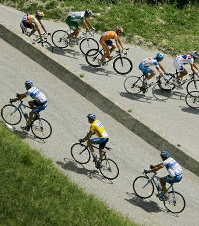 
Six-time defending champion Lance Armstrong, below at center, remains the overall leader at the Tour de France. 
 (Associated Press / The Spokesman-Review)