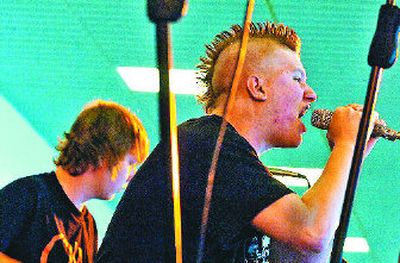 Chris Carder growls out a song while bassist Nicholas Hart plays in the band Trip Wire, which performed at the Kids in Need Concert on Saturday at the Greyhound Park and Event Center in Post Falls. The show, organized by young musicians and friends, raised money for three children's charities. 
 (Jesse Tinsley / The Spokesman-Review)