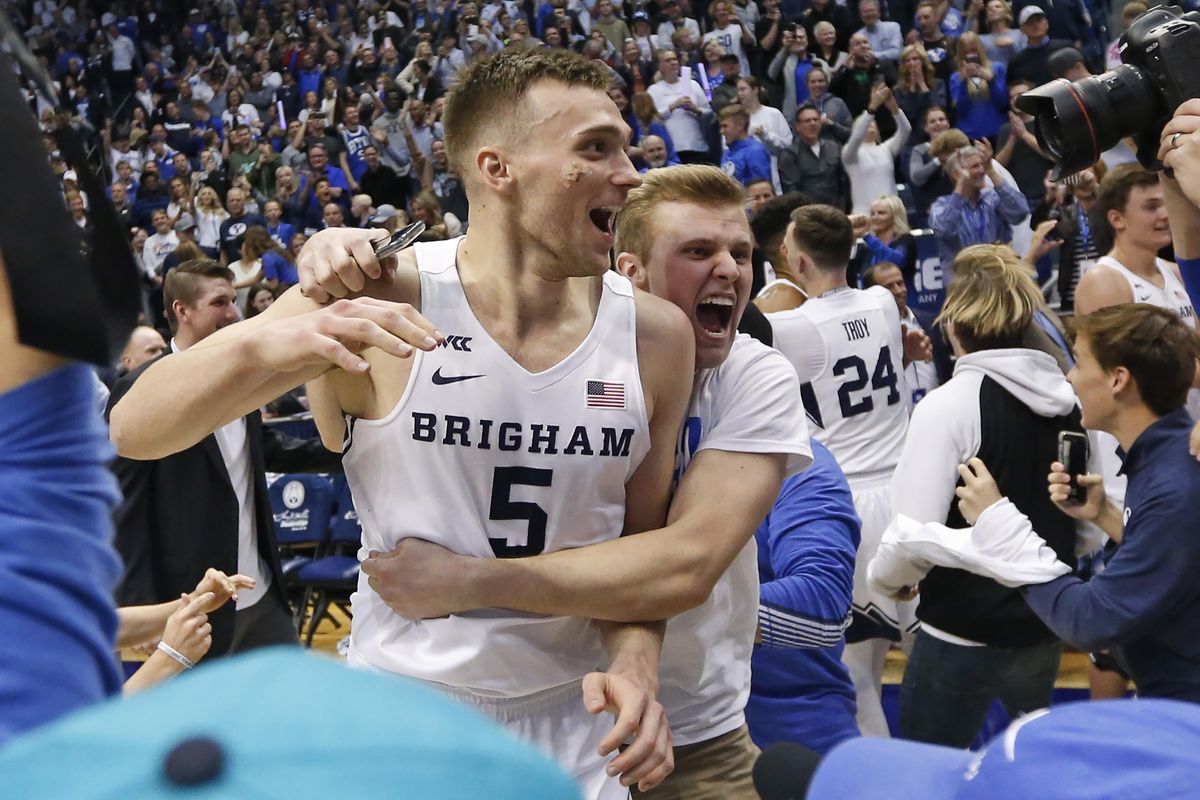 BYU guard Jake Toolson (5) celebrates with fans following the team