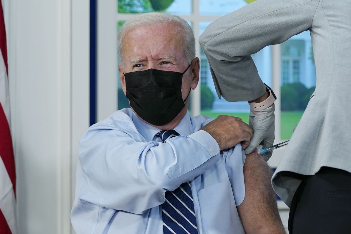 President Joe Biden receives a COVID-19 booster shot during an event Monday in the South Court Auditorium on the White House campus in Washington, D.C.  (Evan Vucci)