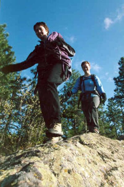 
Maryanne Gaddy, left, and Valerie Wade trek across the granite at Minnehaha Rocks during the rock climbing session in the annual Spokane Mountaineers Mountain School. 
 (Rich Landers / The Spokesman-Review)