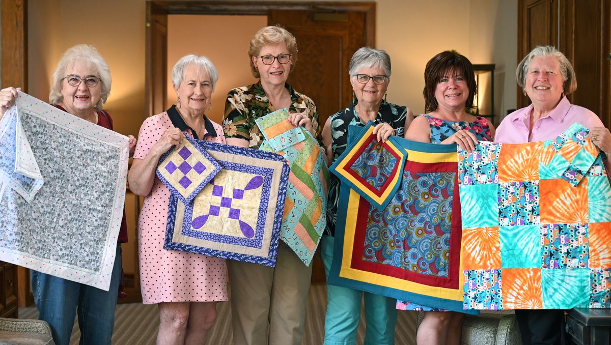 Members of the Emanuel Presbyterian Church Quilters, from left, Noel Kafton, Joyce Miller, Kristen Cejka, Sue Burford, Annette Drennen, of Heritage Funeral & Cremation, and Lorelee Bauer, gather to show some of the memorial and keepsake quilt they made for the Infant Memorial Quilting club on June 14. Heritage Funeral Home provides burial services for many of the youngest in Spokane County. Quilters provide quilts to wrap children in for burial or viewing.  (DAN PELLE/THE SPOKESMAN-REVIEW)