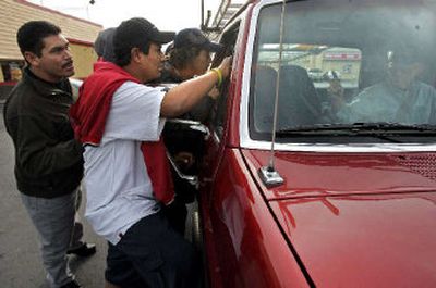 
A group of day laborers surround a truck to get picked up for a job in Las Vegas. Illegal immigrants may number as high as 20 million, according to Bear Stearns in New York. They are spreading beyond traditional immigrant states like California and Texas. They are going West and South, where there is tremendous growth, affordable housing and family networks, to states like Utah, Washington, Colorado, Tennessee and Georgia. 
 (Associated Press / The Spokesman-Review)