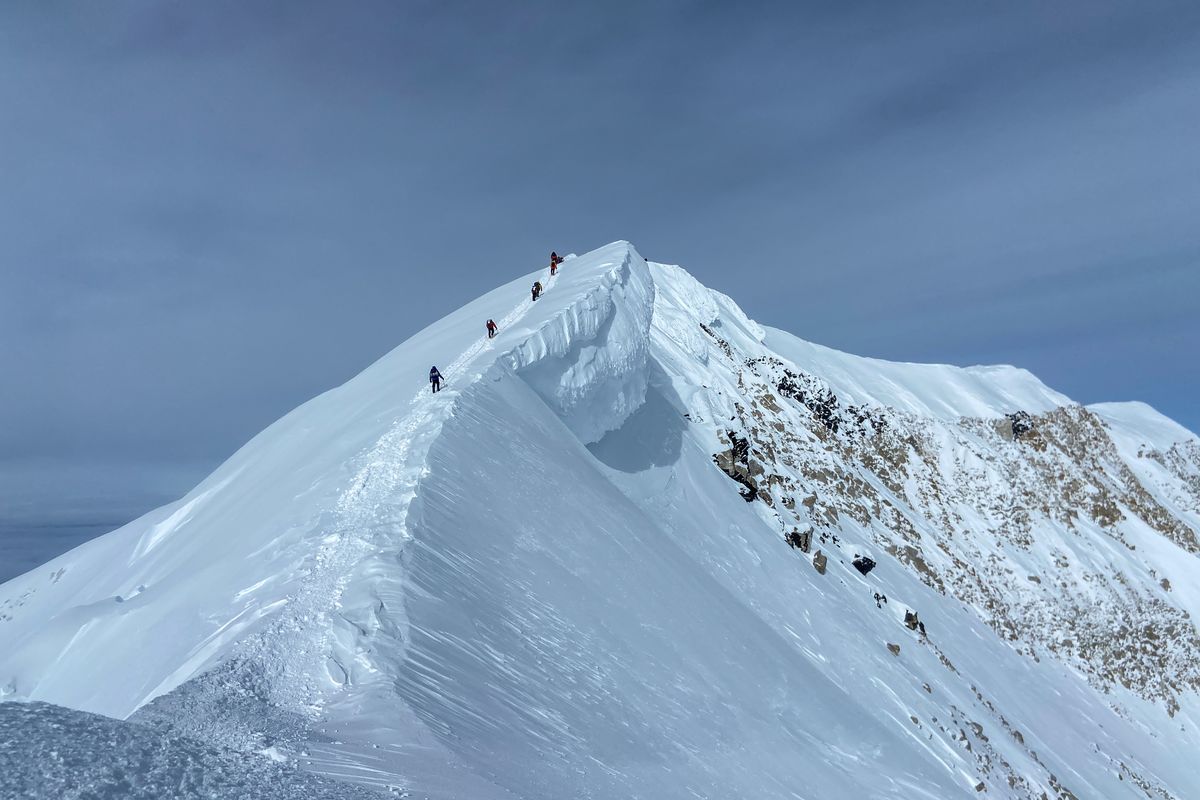Determined climbers move slowly up the final summit ridge of Denali.  (Trisha Thorman)