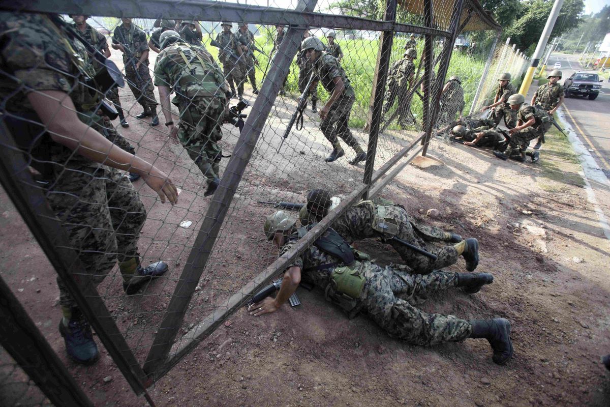 Army soldiers break into the presidential residency in Tegucigalpa, Honduras, on Sunday.  Soldiers arrested President Manuel Zelaya and disarmed his security guards after surrounding his residence.  (Associated Press / The Spokesman-Review)