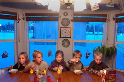 
Keri Drechsel, 5, Travis Shaffer, 9, Emily Dupree, 7, Nic Foeller, 5, and Mason Whittaker, 4, have a snack at the in-home day care of Carlyn Shaffer in Hayden on Wednesday. Proposed changes in  child care laws, including the ratios of children to adults, could affect many day cares. 
 (Jesse Tinsley / The Spokesman-Review)