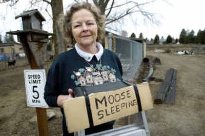 
Myrna Raney holds a sign she used to put near the driveway when a moose was visiting. 
 (Holly Pickett / The Spokesman-Review)