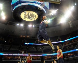 Jeremy Pargo dunks and is framed by bright lights and the NCAA logo in Memphis, Tenn.  (Christopher Anderson / The Spokesman-Review)