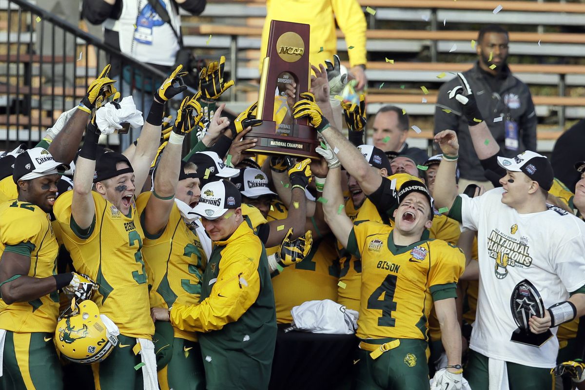 North Dakota State players show off FCS championship trophy on Saturday. (Associated Press)