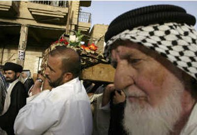 
Mourners carry the body of Abdullah Falaq, an aide to Shiite cleric Grand Ayatollah Ali al-Sistani, from the Imam Ali shrine to his burial spot in the holy city of Najaf south of Baghdad on Saturday. Associated Press
 (Associated Press / The Spokesman-Review)