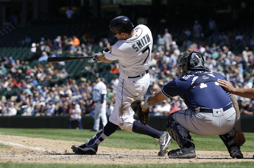 Seattle Mariners' Seth Smith hits a solo home run as San Diego Padres catcher Christian Bethancourt looks on in the fifth inning on Tuesday in Seattle. It was Smith's second home run of the game. (Ted S. Warren / Associated Press)