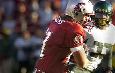 
Cougars tight end Jed Collins wraps up the ball at the end of a long gain. 
 (Christopher Anderson / The Spokesman-Review)