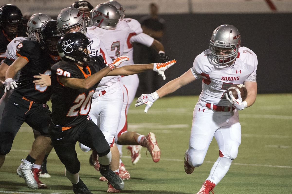Ferris’ Jonny Via, right, eludes Lewis and Clark’s David McKinzy during the first quarter of the Friday night game at Albi Stadium. (Dan Pelle)