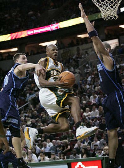 
Ray Allen drives to the basket past Utah defenders in the second half.
 (Associated Press / The Spokesman-Review)
