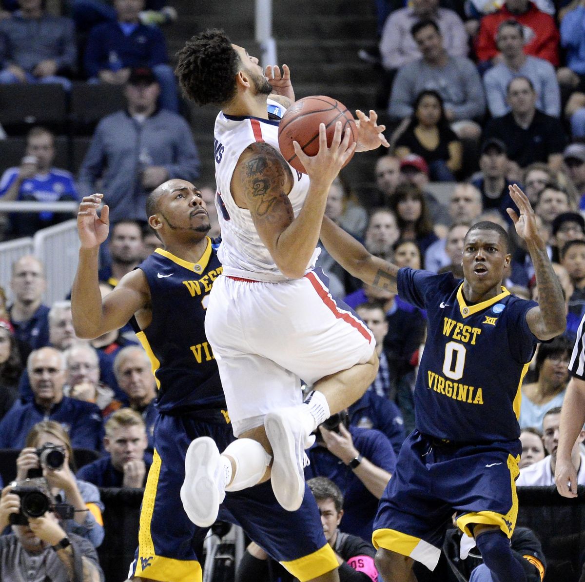 Gonzaga guard Josh Perkins is fouled by West Virginia guard Jevon Carter, left, in the first half of their NCAA Sweet Sixteen game, March 23, 2017, in San Jose. (Dan Pelle / The Spokesman-Review)