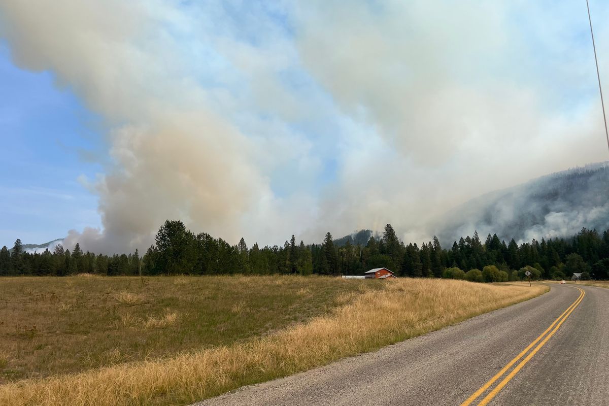 Smoke from the Blackhawk Mountain and Crown Creek fires can be seen billowing over the tree line Sunday afternoon in Stevens County. (Courtesy of Anjel Tomayako/Department of Natural Resources)