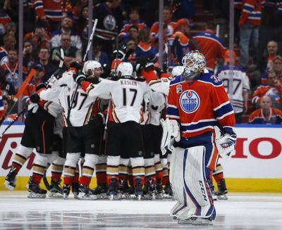 Anaheim Ducks celebrate their overtime victory as Edmonton Oilers goalie Cam Talbot, front, skates past after Game 4 of an NHL hockey second-round playoff series, Wednesday, May 3, 2017, in Edmonton, Alberta. Anaheim won 4-3. (Jeff McIntosh / Canadian Press via AP)