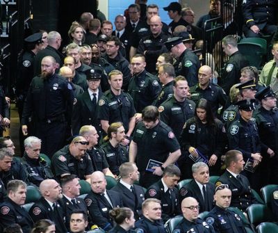 Law enforcement and fire and rescue personnel enter a memorial service for Everett Police Officer Dan Rocha on Monday, April 4, at Angel of the Winds Arena in downtown Everett.  (Associated Press)