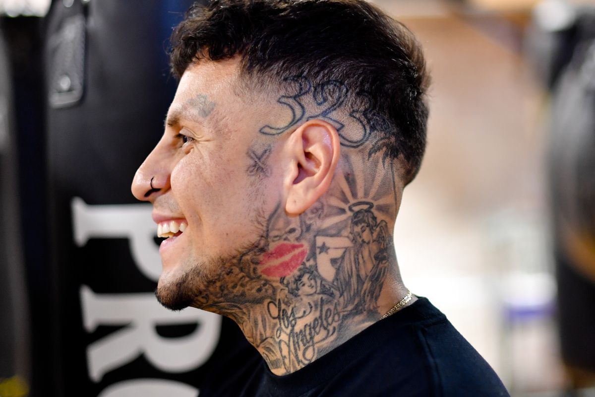 Edwin Magana, laughs while his son Junior trains, on Wednesday, Sep 15, 2021, at the Spokane Boxing Gym in Spokane, Wash. Edwin Magana, is a local barber, who is trying to get his record clean after a stint in California jail during his early years. He