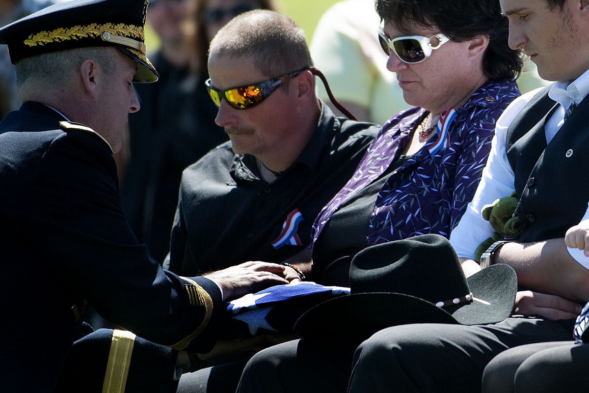 Tina Clouse is presented the U.S. flag in her son’s honor at Riverside Memorial Park Cemetery in Spokane on Saturday.