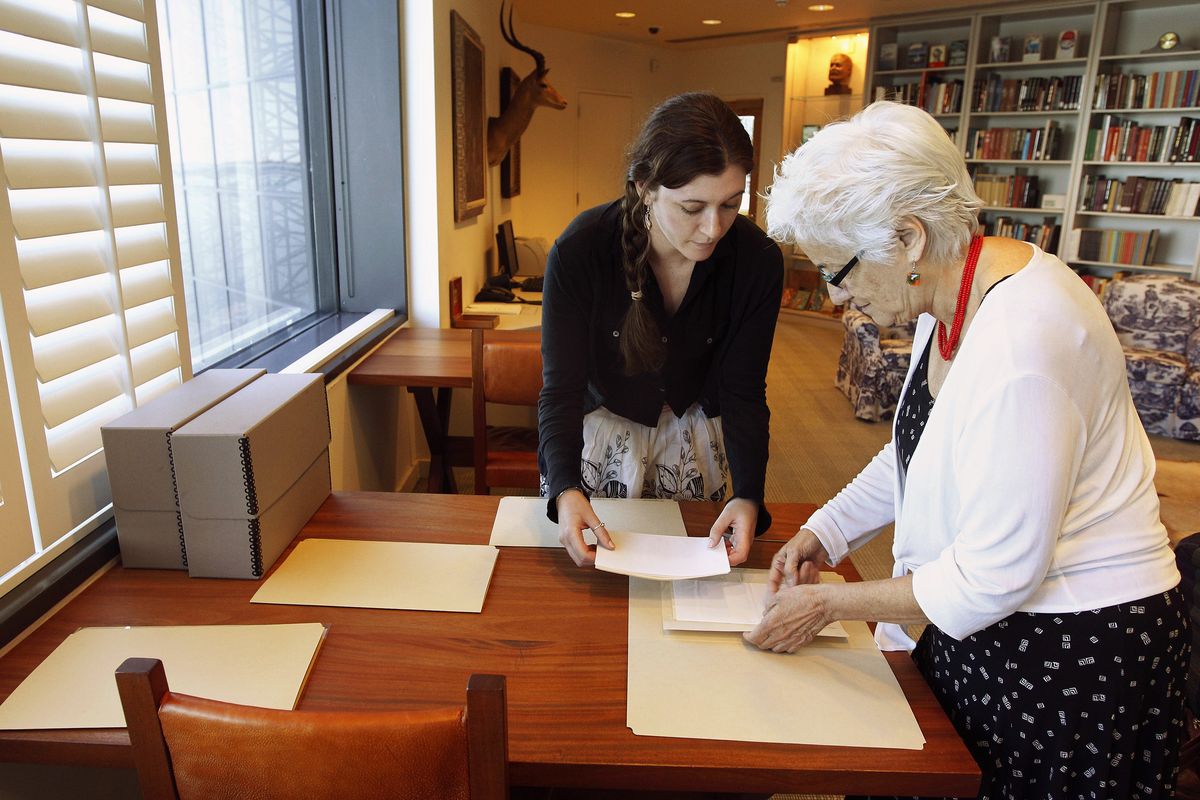 In this Sept. 11, 2012, photo Hemingway curator Susan Wrynn, right, and intern Jessica Green collate documents from the Hemingway collection at the John F. Kennedy Library and Museum in Boston. Among letters written to Ernest Hemingway slated for repair are dispatches from public figures including Hollywood stars Ingrid Bergman and Marlene Dietrich, writers F. Scott Fitzgerald and Gertrude Stein, and Hemingway
