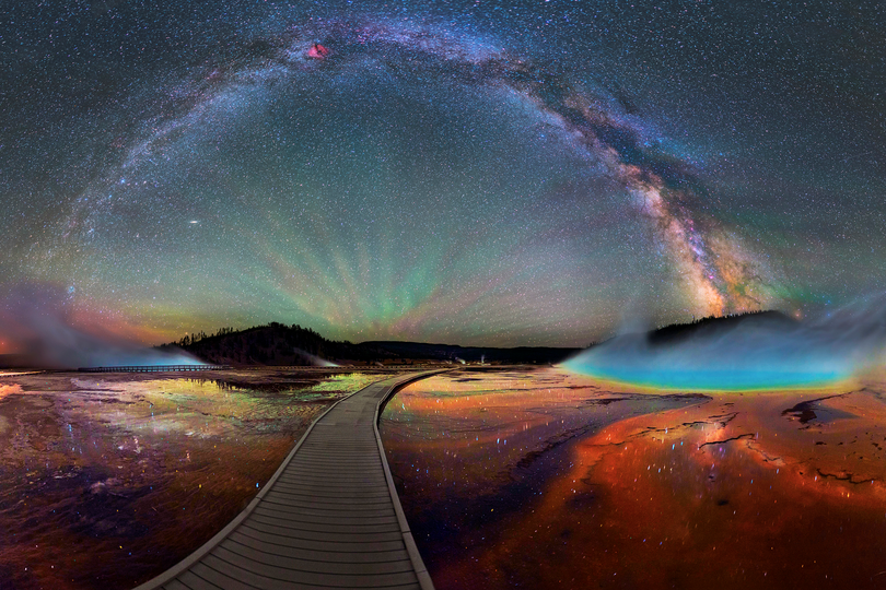 
Midway Geyser Basin in Yellowstone National Park was never so enchanting as in this multi-image panorama shot created under the Milky Way on a boardwalk to Grand Prismatic Spring, the largest hot spring in the park. The image was shared with the national park service by photographer David Lane on Instagram  (David Lane)