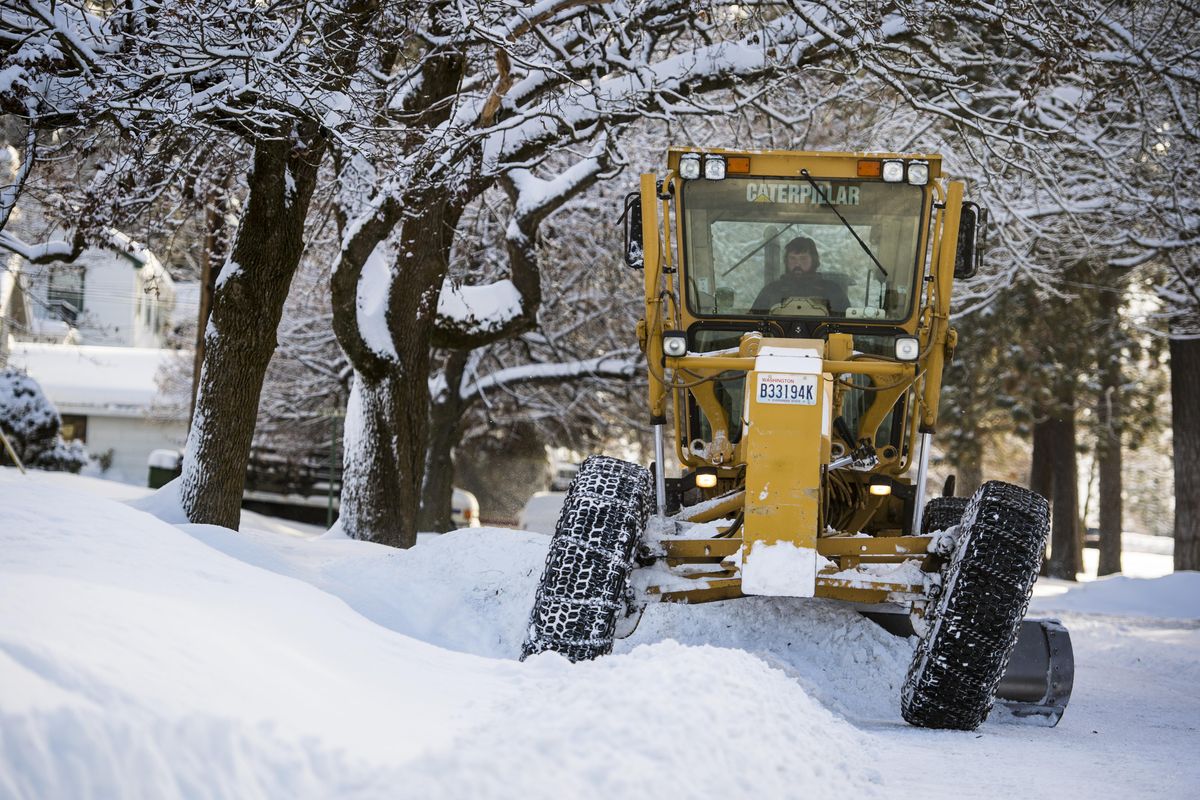 A City of Spokane snowplow removes snow from South Jefferson Street on Spokane’s South Hill, Tuesday, Jan. 10, 2017. (Colin Mulvany / The Spokesman-Review)