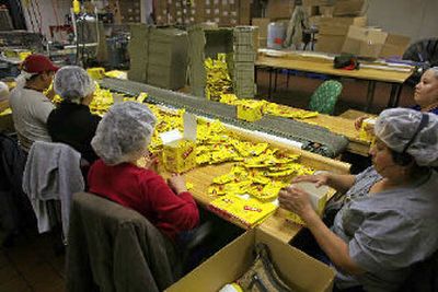 
Workers package units of Carmex at the Carma Laboratories Inc., which finally hired its first salesman this year.
 (Associated Press / The Spokesman-Review)