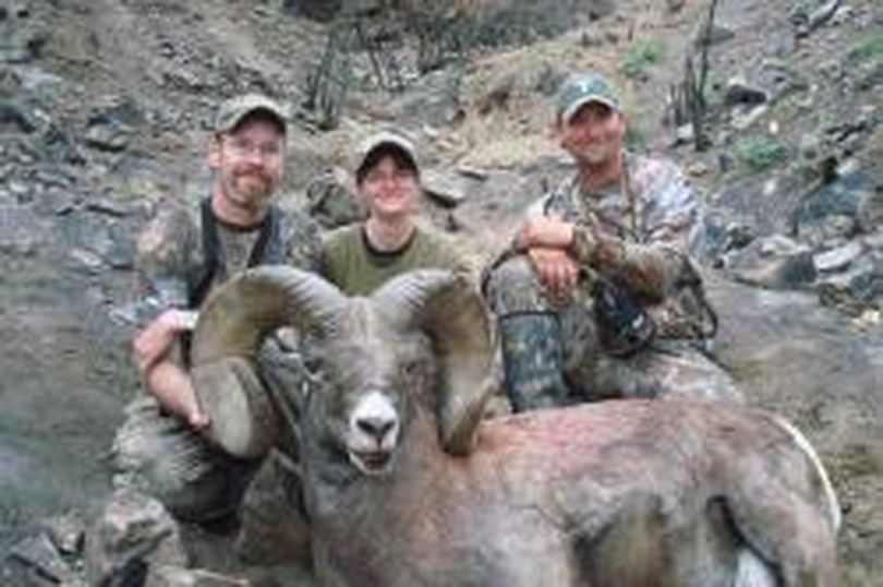 Aaron and Angie Roth and a guide pose with Aaron's California bighorn ram after a 2010 hunt in Chelan County. The ram scored nearly 191 Boone and Crockett points and ranked as Washington's No. 1 California bighorn. (Courtesy photo)