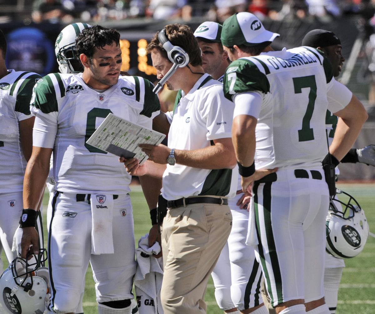 New York Jets quarterback Mark Sanchez and Kevin O’Connell (7) talk to offensive coordinator Brian Schottenheimer  during a game against the New England Patriots on Sept. 20, 2009, at Giants Stadium in East Rutherford, N.J. (Bill Kostroun / AP)