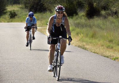 
Penny Simonson, front, and Luanne Castoldi recently rode to the state line and back. Both are on a relay team for the Valley Girl Triathlon. 
 (Photos by Liz Kishimoto / The Spokesman-Review)