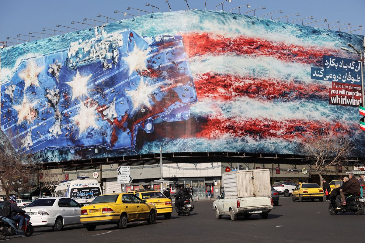 People walk past an anti-U.S. billboard on a street in Tehran, Iran, February 17, 2026.  (Majid Asgaripour)
