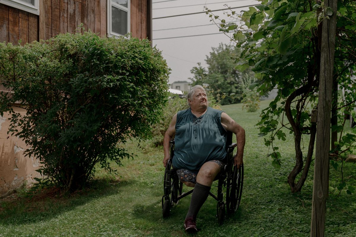 Debbie Blankenship wheels herself through her garden. (Caroline Gutman/For The Washington Post)