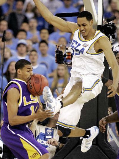 
It's adding insult to injury as LSU's Garrett Temple takes the brunt after UCLA's Ryan Hollins scores. 
 (Associated Press / The Spokesman-Review)