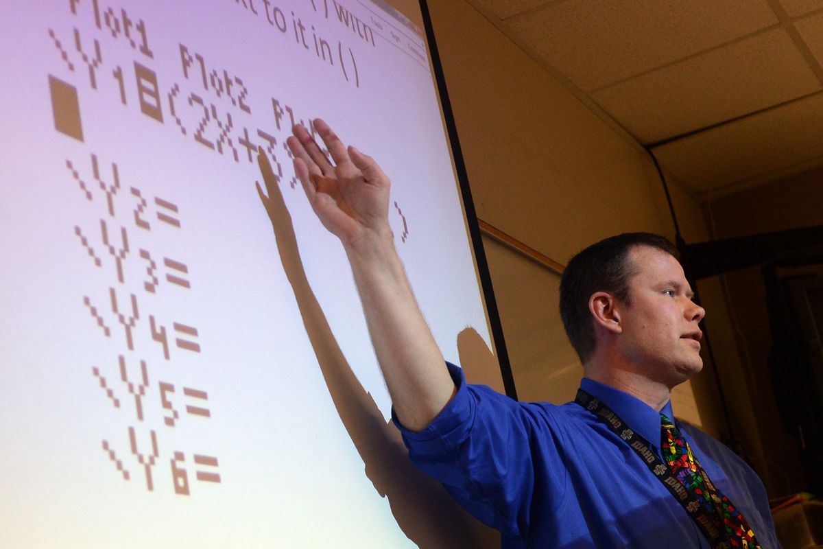 Mike Conklin, a math teacher at University High School, lectures about using a graphing calculator in pre-calculus. (Jesse Tinsley)