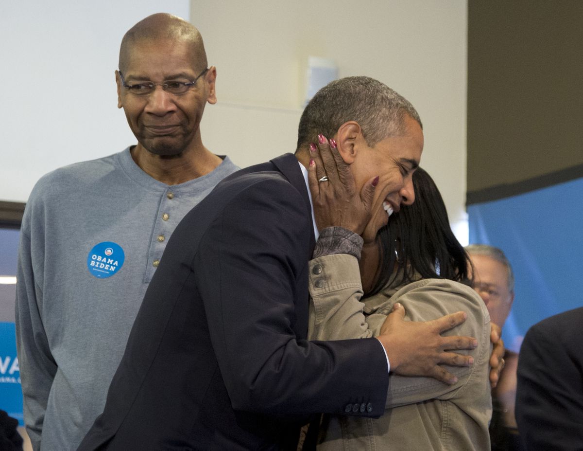 President Barack Obama is embraced by a volunteer as he visits a campaign office the morning of the 2012 election, Tuesday, Nov. 6, 2012, in Chicago. (Carolyn Kaster / Associated Press)