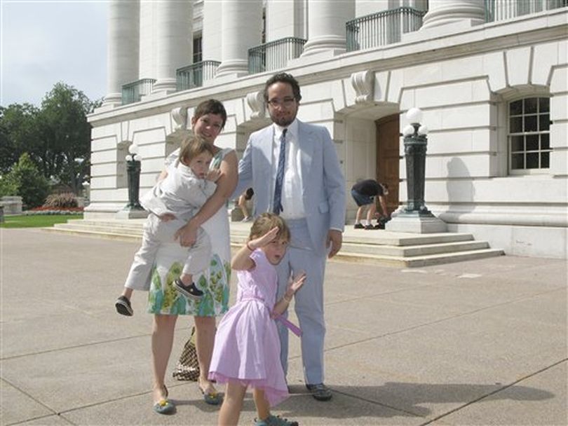 In this Aug. 21, 2010 file photo provided by the Myers family, John Myers, right, his wife Katharine, children Charlie, left, and Matilda, center, of Bloomfield, N.J., pose for a photo in front of the Wisconsin State Capitol in Madison, Wis., as a man in the background is seen picking up John Myers' bag. The Wisconsin man who stole the bag was identified and has been sentenced to five days in jail. Fifty-nine-year-old Glenn R. Lambright was given credit for time already served. The Wisconsin State Journal reported Saturday, Oct. 30, 2010, he was also fined nearly $500.  ((AP Photo/Myers Family via Wisconsin State Journal) )