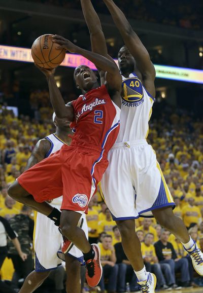 Los Angeles guard Darren Collison shoots against Golden State forward Harrison Barnes during the first half on Thursday. (Associated Press)