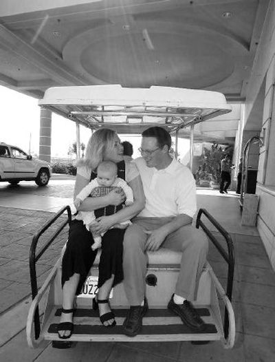 
Kurt Barrett, Deanna Barrett and their 5-month-old daughter Ava get a ride in a golf cart to a nearby beach at the Loews Coronado Bay Resort in Coronado, Calif. 
 (Associated Press / The Spokesman-Review)
