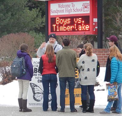 A member of the Abolitionist Society of North Idaho talks to students outside Sandpoint High School during a demonstration the group held there in January. (Courtesy Photo)