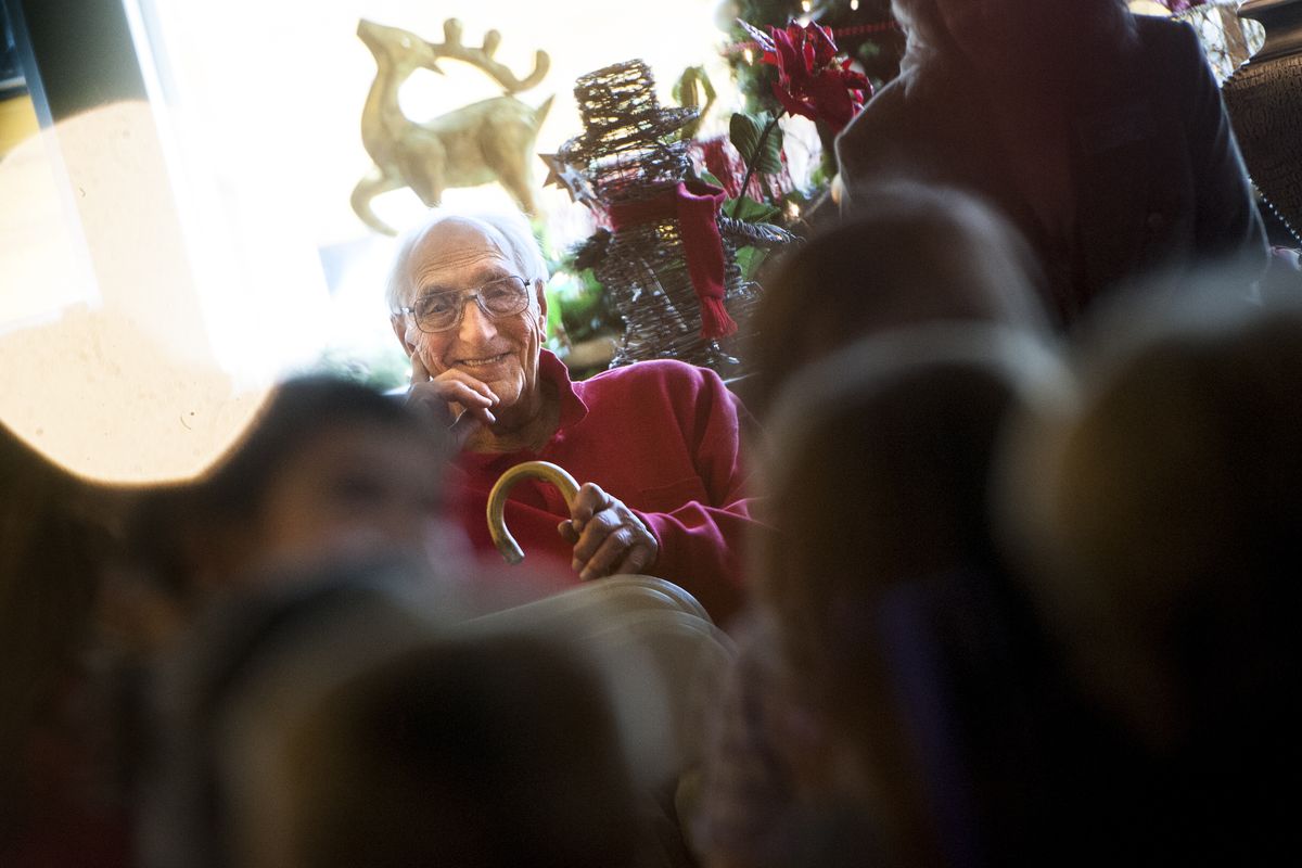 Tom Larson, 98, smiles as Summit School kindergarten students sing Christmas carols to him and other seniors on Thursday at Orchard Crest Retirement Community. (Tyler Tjomsland)